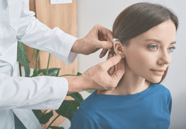 hearing aid being fit on a woman